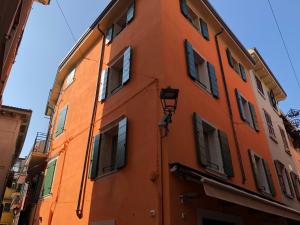 an orange building with windows on a street at Appartamenti Ca' Gabri & Cici in Garda