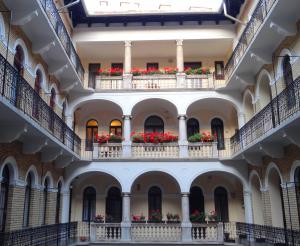 an empty hallway of a building with flowers on balconies at Apartman Budapest City Center in Budapest