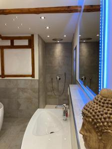 a bathroom with a sink and a shower at Saarburg Wine Apartments in Saarburg