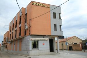 a building on the corner of a street at Hostal Restaurante Cuatro Caminos in Calera y Chozas