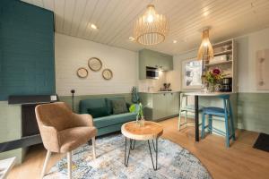 a living room with a couch and a table at Center Parcs Erperheide in Peer