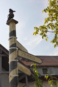 a pole with street signs in front of a building at Riffelhof in Burgrieden
