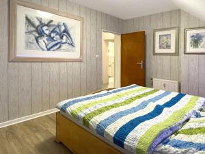 una camera da letto con un letto con un piumone a righe di Ferienwohnung Köln-Poll a Colonia