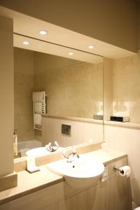 a bathroom with a sink and a large mirror at Mulroy Woods Hotel in Milford