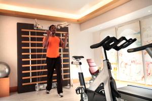 a woman talking on a cell phone in a gym at Five Seas by Inwood Hotels in Cannes