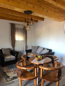 a living room with a table and chairs and a couch at house on the hill in Cetinje