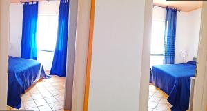 A bed or beds in a room at Furore Coast Rooms