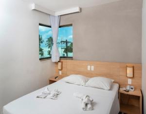 Ліжко або ліжка в номері Hotel Porto Maceió