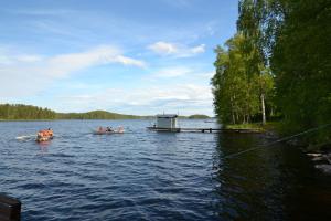 a group of people in boats on a lake at GERIKA 2 in Enonkoski