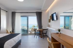 a hotel room with a bed and a table and chairs at Eleven Boutique Suites in Stavromenos