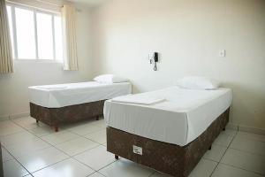 Postel nebo postele na pokoji v ubytování Hotel Colina