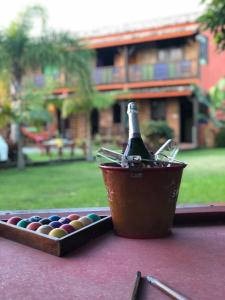 a bottle of champagne in a bucket on a table at Pousada Laranja Lima in Praia do Rosa