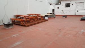 un grupo de mesas y bancos en una habitación en Casona de Sol en Mar del Plata
