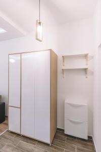 a white cabinet in the corner of a room at VS Studio Apartmani Banja Koviljača in Banja Koviljača