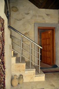 a staircase in a building with a wooden door at Luwian Stone House in Goreme