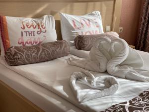 a bed with two hearts on it with pillows at Hotel Anhea in Veliko Tŭrnovo
