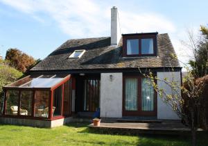 an extension to a house with sliding glass doors at Sylvan Orchard in Gullane