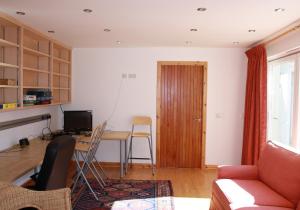 a living room with a table and a desk at Sylvan Orchard in Gullane