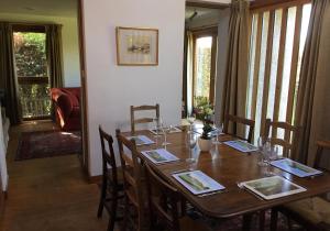 a dining room with a wooden table with chairs at Sylvan Orchard in Gullane