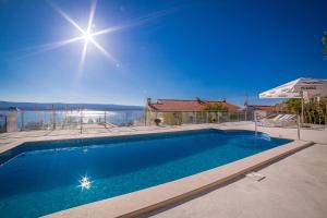 een zwembad in een huis met uitzicht op het water bij Apartments Emil in Lokva Rogoznica