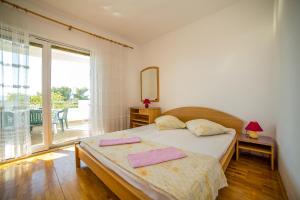 a bedroom with a bed with two towels on it at Apartments Emil in Lokva Rogoznica +96 photos