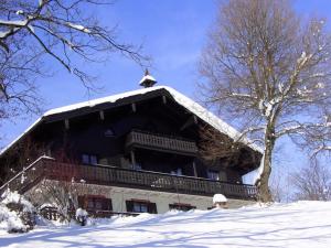 a large building with a snow covered roof at Feichtenhof in Siegsdorf