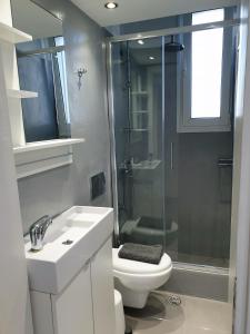 a bathroom with a sink and a toilet and a shower at KYMA Apartments - Athens Acropolis 7 in Athens
