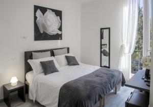 a bedroom with a large white bed with two pillows at Le Stanze dei Fiori in Bologna