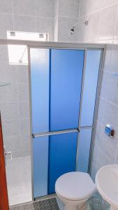 a bathroom with a shower with a toilet and a sink at Nacional Park Hotel Lages in Lages