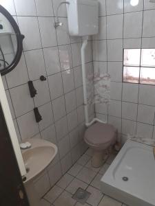 a white bathroom with a toilet and a sink at Kuca za odmor Zlatibor in Zlatibor +24 photos