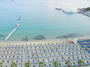 an aerial view of a beach with umbrellas and boats at Mykonos Dove Beachfront Hotel in Platis Yialos Mykonos