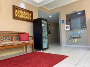 a lobby with a vending machine and a red rug at Pousada VIP in Pôrto Real