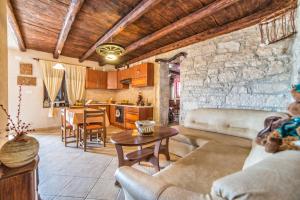 a living room with a couch and a table at Holiday House Eleonora in Barban
