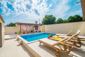 a villa with a swimming pool and a patio at Holiday House Eleonora in Barban