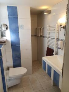 a bathroom with a toilet and a sink at T&K Appartements in Bad Homburg vor der Höhe +28 photos