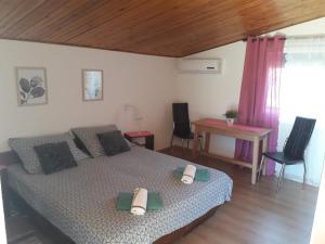 a bedroom with a bed and a table and chairs at Apartments Carev 1293 in Jezera