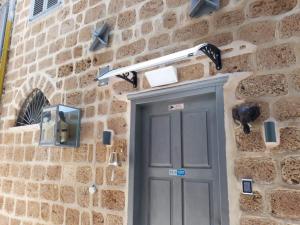 a stone wall with a door and a light above it at Salah Aldin House in Acre