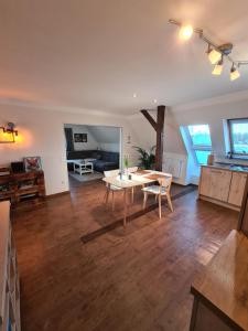 a living room with a table and a couch at Herrlicher Nord und Süd-Blick direkt am Nord-Ostsee-Kanal in Breiholz