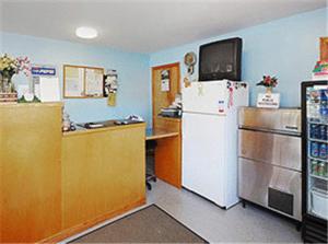 a kitchen with a white refrigerator and a counter at Atlantic Motel in East Wareham