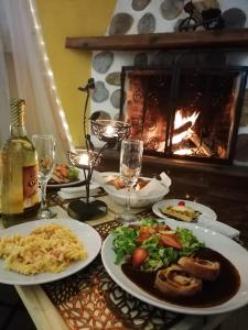 a table with plates of food and a fireplace at Hotel Posada El Camino in Chignahuapan