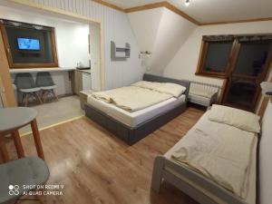 
Łóżko lub łóżka w pokoju w obiekcie Dom Wypoczynkowy Słoneczny
