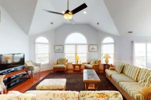 a living room with a couch and a tv at Poetry in Motion #7-K in Avon