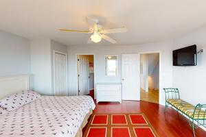 a bedroom with a bed and a ceiling fan at Poetry in Motion #7-K in Avon