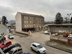 a parking lot with cars parked in front of a building at Station's Room in Avellino