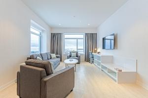 a living room with a couch and a table at Aqsarniit Hotel and Conference Centre in Iqaluit