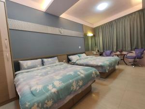 Postelja oz. postelje v sobi nastanitve Nice Neighbors Homestay