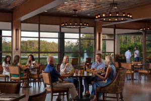 a group of people sitting at a table in a restaurant at Four Seasons Resort Orlando at Walt Disney World Resort in Orlando