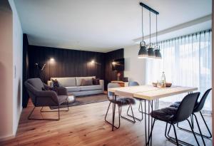 a kitchen and living room with a table and chairs at Walser ART in Mittelberg