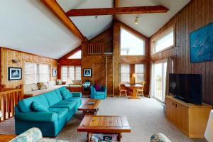 a living room with a blue couch and a tv at Three Sheets to the Wind #70-1 in Avon