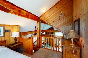 a bedroom with wooden walls and a bed in a room at Three Sheets to the Wind #70-1 in Avon